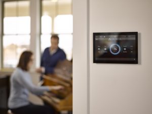 Wall mounted control panel, people in background